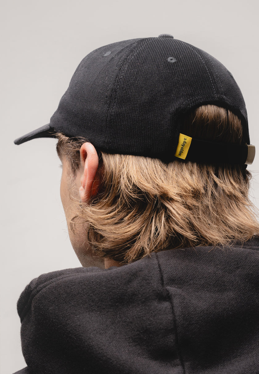 a black corduroy cap